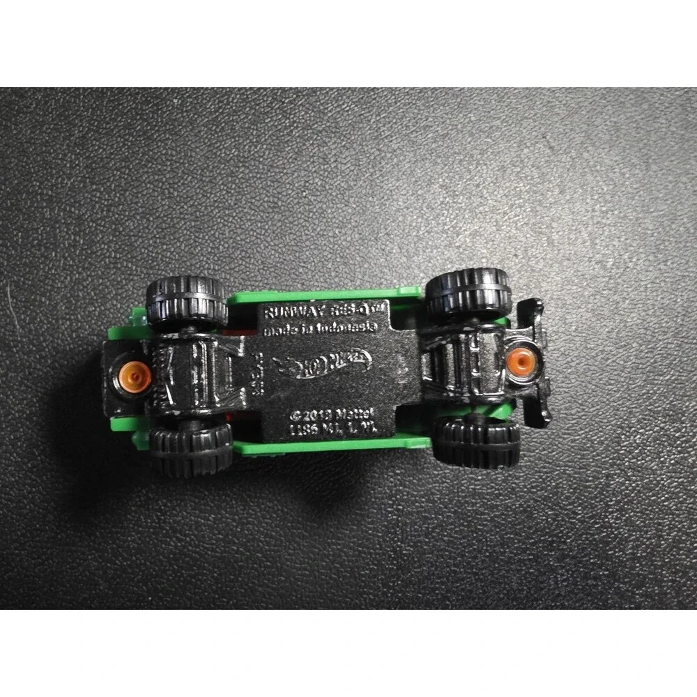 Lot of 4 loose Hot Wheels vehicles in pre-owned condition.